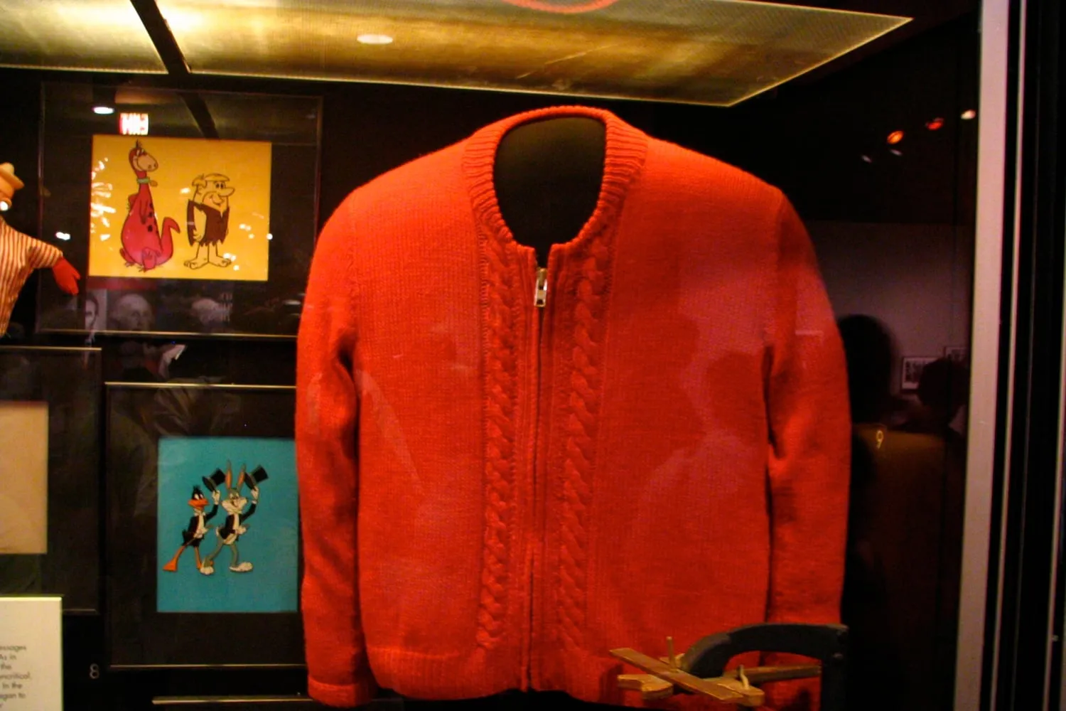 A knitted cardigan and a coat on a rail