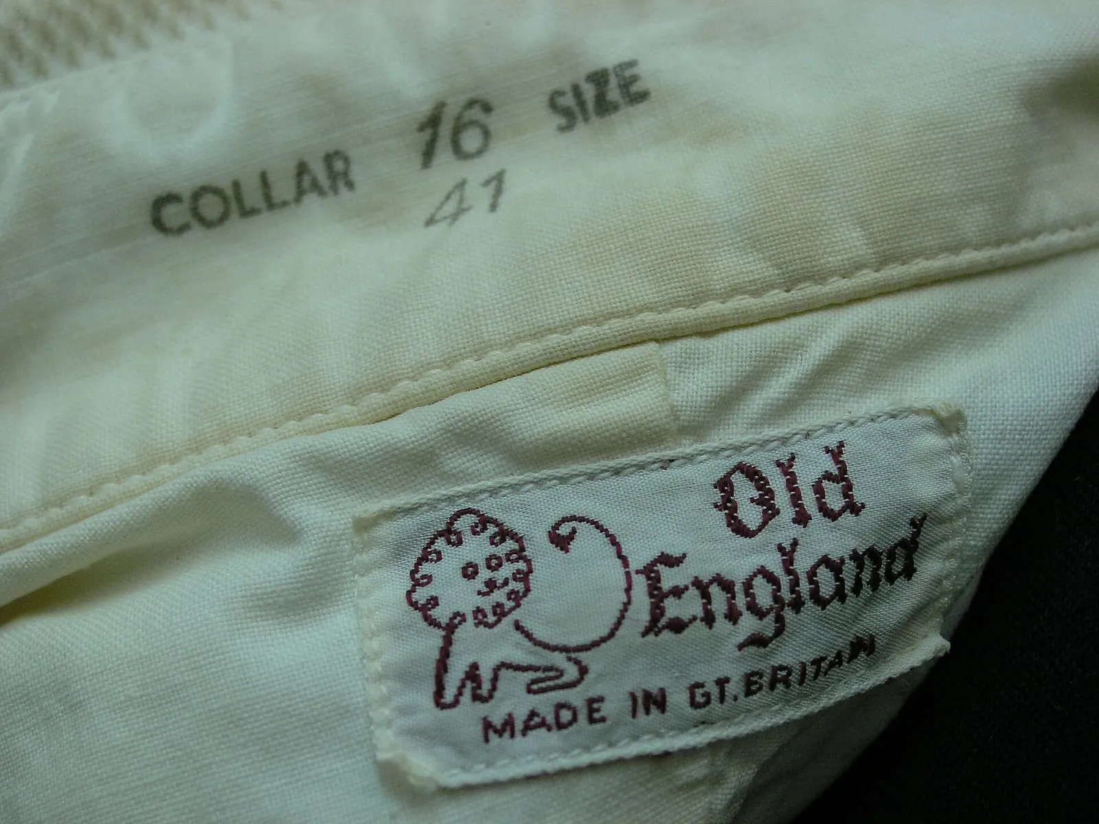 A white dinner shirt collar stamped Collar 16 Size, with a woven Old England label sewn below it