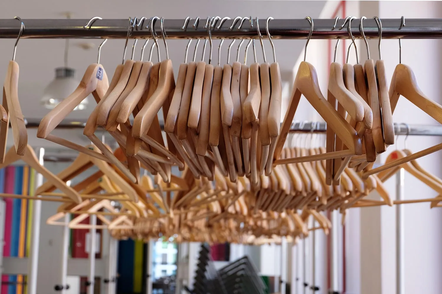 Clothes on hangers lined up along a rail
